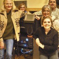 sistersmovie-lisa clausen left and her sisters movie house staff with the new christie digital system
